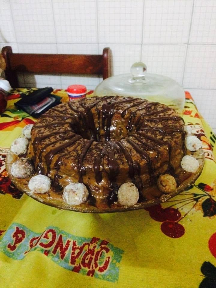 Bolo de banana com recheio de doce de leite, cobertura de chocolate meio amargo e brigadeiros de banana